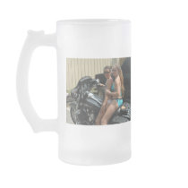 2 women sitting on a motorcycle. mugs