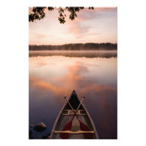 A canoe rests on the shore of Pawtuckaway Lake