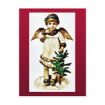 A girl dresses like an angel catching christmas tr post card