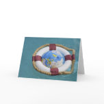 A life preserver and world globe floating on card