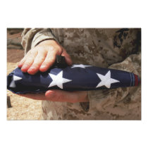 A soldier holds the United States flag