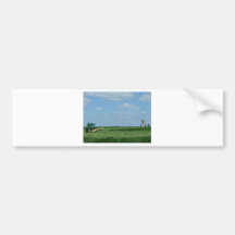 a tractor cutting wheat fields and a water tower bumper sticker
