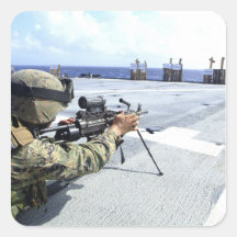 A US Marine adjusting his weapon Square Stickers