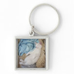 A white cat sleeping in a laundry basket, key chain