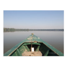 A wooden canoe made of Eucalyptus tree floats in Post Card