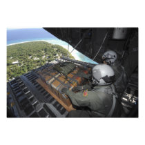Airmen push out a pallet of donated goods