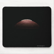 American football ball on black background mousepads