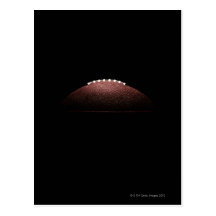 American football ball on black background postcards