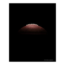 American football ball on black background posters