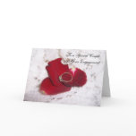 An Engagement Card Diamond Ring And Rose Petals