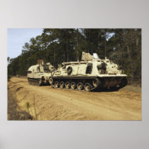 An M-88 recovery vehicle begins to tow an M992 Posters