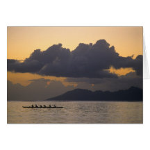 An outrigger canoe team practices off the coast cards