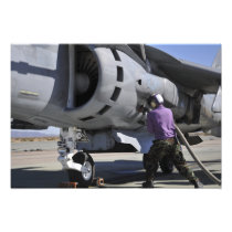 Aviation fuel technician attaches a fuel line
