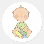 baby boy holding easter egg round sticker