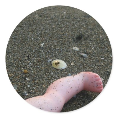 Beach pollution broken doll leg on sand round sticker by SusansZooCrew