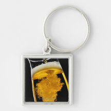 Beer been poured into glass, studio shot keychains