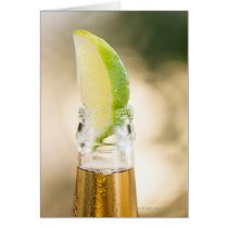 Beer bottle with lime wedge greeting cards