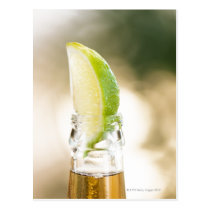 Beer bottle with lime wedge postcards