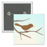 Bird sitting on branches of a tree button