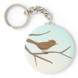 Bird sitting on branches of a tree keychain