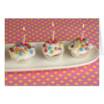 Birthday muffins with icing, sprinkles and card