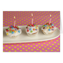 Birthday muffins with icing, sprinkles and card