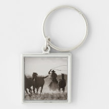 Black and White photo of a Cowboy Lassoing Horses Key Chain