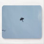 Black Crow Flying Fast Over The Head In Blue Sky Mousepads