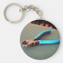 Blue side cutter on table keychains
