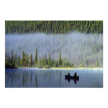 Boys fishing from canoe with mist in photograph