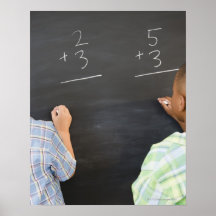 Boys solving math problems on blackboard print