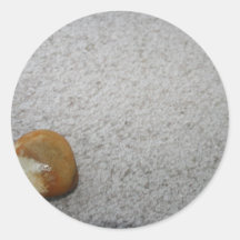 Brown and white round rock on cream carpet sticker