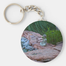Buda meditating by the stream keychain