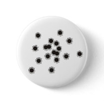 Bullet holes from a rifle or gun, possibly shotgun buttons