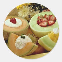 Cantaloupes and melons on cutting board with flowe stickers