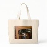 cat hiding in kitchen tote bag