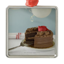 Chocolate cake with missing slice on table, christmas ornaments