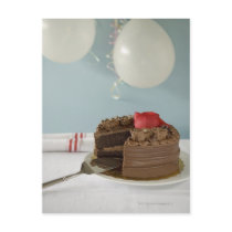Chocolate cake with missing slice on table, postcards