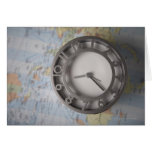 Close-up of a clock in front of a map greeting card