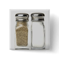 Close-up of a salt and a pepper shaker buttons