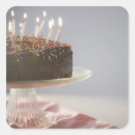 Close up of chocolate birthday cake with candles square sticker
