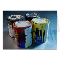 Close-up of four paint cans cards