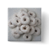 Close-up of powdered doughnuts in a plate buttons