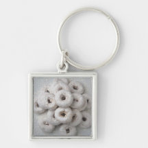 Close-up of powdered doughnuts in a plate key chain