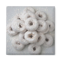 Close-up of powdered doughnuts in a plate magnets