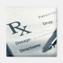 Close up of prescription pad and pen refrigerator magnets