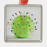 Close-up of straight pins inserted into a ball christmas ornament