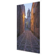 Cobbled alleyway of old city lit up at night canvas print