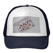 Colourful fishing hooks kept in fly box mesh hats