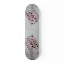 Colourful fishing hooks kept in fly box skate deck